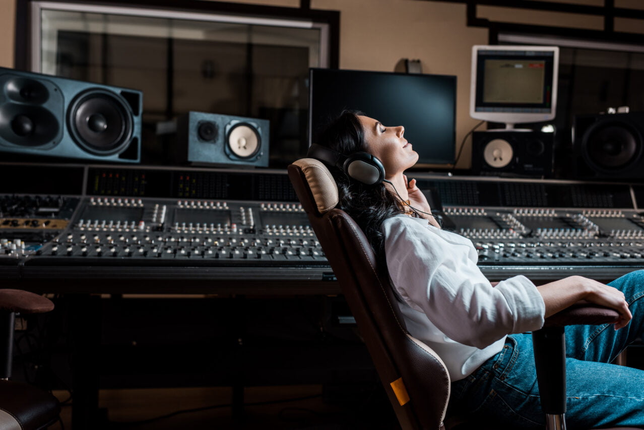 pretty sound producer listening music in headphones while sittin